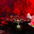 Red leather choker necklace with gold metal hardware, rivets, and a hollow bell pendant. - Palace Bell + Chain + Gift Box / Red
