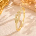 Detailed shot of exquisite gold infinity knot pavé rhinestone bracelet, luxury jewelry design. - Gold