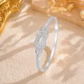 Close-up detail of the dazzling infinity knot diamond bracelet, sparkling crystal stones. - Silver
