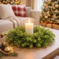 Close-up of a lush green artificial boxwood wreath with a lit candle on a table - 60CM