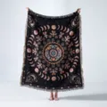 Woven bohemian blanket with moon phases and mandala design held up in a studio setting - Moon Phase Mandala (XT1201-4) / 130x160cm