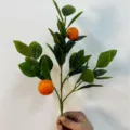 Ramo di arancio artificiale realistico con foglie verdi e due frutti arancioni brillanti - Ramo d'Arancia / 1 Pezzo