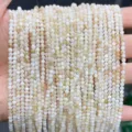 Macro view of 3mm natural freshwater shell beads with oily flower texture and sheen - White (Natural Iridescent Freshwater Shell)