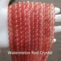 Close-up of translucent watermelon red synthetic crystal round beads for DIY jewelry - 12mm/Approx 31pcs / Synthetic Cherry Quartz