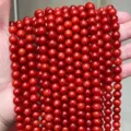 Gros plan détaillé de perles rondes en calcédoine rouge pour la création de bijoux DIY - 6mm (Environ 60 Perles/Brin) / Rouge Vif