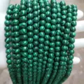 Macro detail of synthetic malachite beads showing green and black banding patterns - 8mm Pack (Approx 47 Pieces) / Synthetic Green Malachite