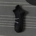 Detail view of men's black athletic sport sock with breathable knit pattern and white stripes. - One Size / Quarter / Black