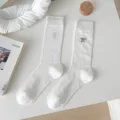 White mid-calf socks for women featuring cute black bow embroidery, summer thin breathable style. - White