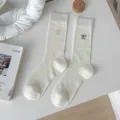 White ribbed crew socks with cute black bow embroidery, chic balletcore style for women. - Cream