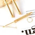 Portable brass ear pick tool set with keyring, durable metal ear cleaner for daily hygiene. - Gold