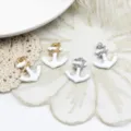 Detail view of white enamel anchor charms with crystal accents in gold and silver - Anchor (18K Gold Tone) / 19.7x23mm / White
