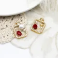 Detail view of 18K gold plated perfume bottle pendants with zircon and red gemstones. - Hollow Red Zirconia Perfume Bottle Style (A0103) / 18*27mm