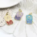 Detailed macro view of retro tarot sun pendants in multiple colors with gold plating - Champagne Dark Red Sun / 16x29mm