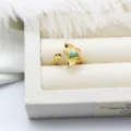 Macro detail of a colorful enamel butterfly adjustable ring with a pearl setting cup. - Butterfly Design