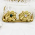 Detailed macro view of 18K gold plated dragon head rings with green and clear gemstones - Dragon Head Style / White Zirconia Dragon