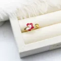 Detailed macro view of enamel flower and bee adjustable ring with DIY pearl setting - Red Flower Bee Style