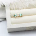 Close-up of elegant light blue and white enameled coral ring with inset zircons - Coral Style