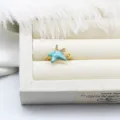 Detailed view of blue enamel starfish adjustable ring with gold plating and sparkling accents - Starfish Rhinestone Style