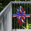 Patriotischer Türkranz zum 4. Juli mit roten, weißen und blauen Ähren am Balkongeländer - Weizen Swag / Pappbox
