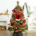 Festive Christmas tree decorated with burgundy flocked balls, red bows, and ribbons - 35-Piece Red Series Ornament Gift Set