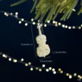 White violin Christmas tree ornament featuring an intricate hollow carved design - White Violin / Iridescent Pearlescent