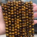 Gros plan sur des perles en œil de tigre jaune naturel avec effet chatoyant unique - 10mm environ 37pcs / Oeil de Tigre Jaune Naturel 7A