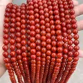 Close-up view showing the glossy texture of persimmon red South Red Agate round beads - 6mm (Approx. 60 Pcs) / Optimized 2nd Gen Southern Red Agate