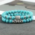 Close-up detail van turquoise kraalarmbanden met een boeddha hoofd en zilveren buis. - Kleur 2
