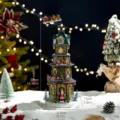 Large light-up rotating Christmas tower music box with moving train and Santa Claus - Lighthouse Musical Box