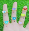 Close-up detail of colorful evil eye heart zirconia rings showing exquisite pave setting. - Heart / Light Pink