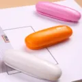 Portable mini stapler with cute capsule design, lightweight desktop stapling tool for office school. - White