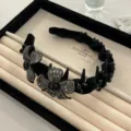 Elegant black velvet headband with sparkling rhinestone flowers and decorative spikes for women - Flower