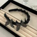 Elegant black hairband featuring glittery butterfly ornaments and subtle spiked details - Butterfly