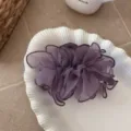 Elegant purple mesh ruffled hair claw clip displayed on a white shell decorative plate - Purple