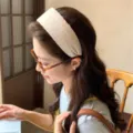 Cream polka dot wide headband worn by model in a minimalist lifestyle setting - Khaki