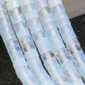 Close up of 2x4mm white translucent disco disc loose gemstone beads for DIY jewelry making. - Milky White