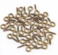 Close-up detail of bronze eye screws for DIY handmade hanging ring craft materials. - Antique Bronze