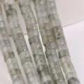 Close-up detail of grey stone rondelle spacer beads for DIY jewelry making and bracelets. - Gray