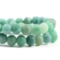 Detailed macro shot of green weathered agate beads, showing unique cracked texture and vibrant tone. - 6