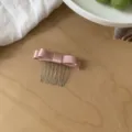 Elegant pink satin bow hair comb clip accessory for stylish side hair decoration and fixing. - Pink
