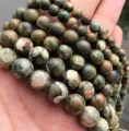 Close-up detail of natural patterned stone round beads, semi-finished DIY handmade jewelry crafting. - Natural Stone