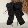 Elegant black polka dot bow hair clip with long flowing ribbons and delicate pearl accents - Satin Polka Dot Black