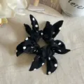 Elegant black hair scrunchie featuring white polka dots and sweet bunny ear bow design. - Black Polka Dot