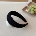 Minimalist solid black wide headband featuring a stylish ribbed knitted texture for women - Black