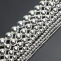 Close-up detail of shiny silver round spacer beads strings for jewelry making crafts. - 6mm (Approx. 62 Beads per Strand) / Electroplated Silver