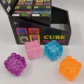 Close-up view of four colorful 3D cube squeeze stress relief toys with display box - Cube Style / 1 Piece