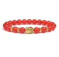 Detailed view of red agate beaded bracelet featuring a golden Buddha head charm and spacer beads. - Red Agate