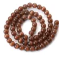 Close-up detail of brown cat eye loose beads, drilled round beads for DIY bracelet parts. - Color 15
