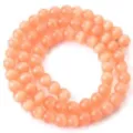 Detailed shot of peach cat eye beads strand, perfect for DIY jewelry making and bracelets. - Color 16