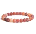 Close-up detail of frosted weathered agate beaded bracelet, featuring vibrant crackle texture. - Gradient